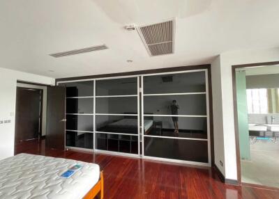 Modern bedroom with hardwood floors and fitted wardrobes
