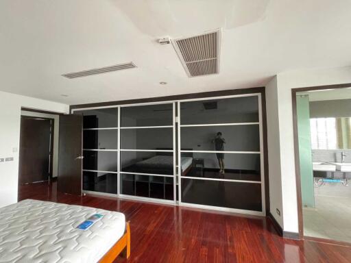 Modern bedroom with hardwood floors and fitted wardrobes