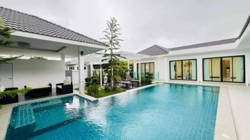 Modern outdoor area with a swimming pool and adjacent seating