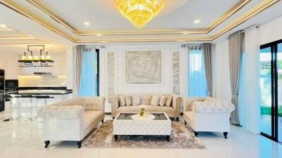 Spacious and elegant living room with chandeliers and luxurious furnishings