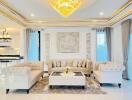 Spacious and elegant living room with chandeliers and luxurious furnishings