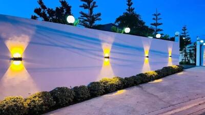 Outdoor area with illuminated wall and plants