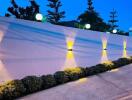 Outdoor area with illuminated wall and plants