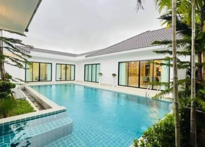 Luxury outdoor pool area with surrounding buildings