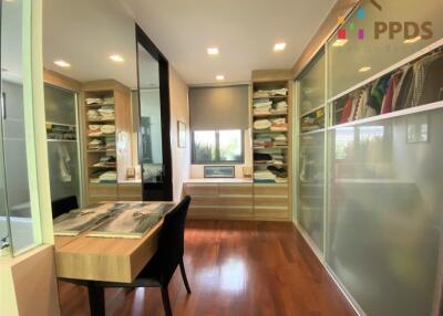 Spacious dressing room with wooden flooring and ample storage