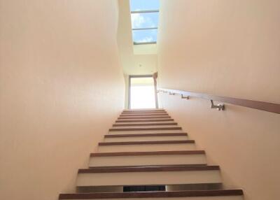 Bright staircase with skylight and modern handrail