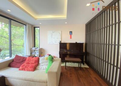 Modern living room with large window and piano