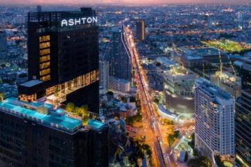 Cityscape view with illuminated buildings and busy streets at dusk.