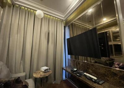 Living room with TV, curtains, and a marble table