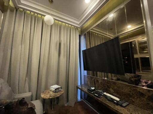 Living room with TV, curtains, and a marble table