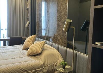 Modern bedroom with double bed, reading lamps, and side table