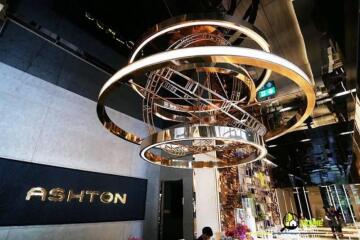 Entrance hall with modern chandelier and wall sign