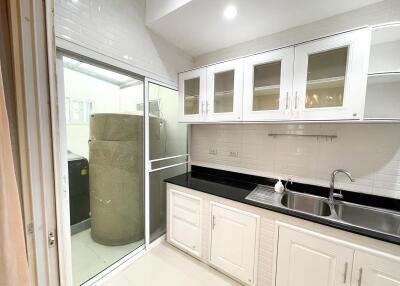 Bright kitchen with white cabinetry and black countertops