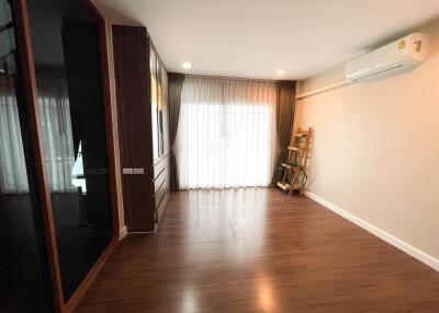 Spacious living room with wooden flooring and ample natural light