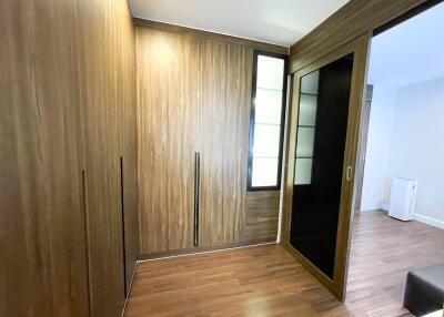 Bedroom with wooden closet and sliding doors