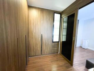 Bedroom with wooden closet and sliding doors