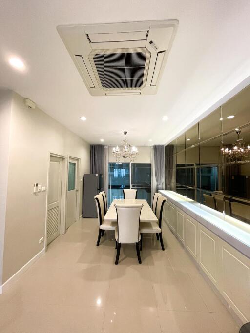 Modern dining room with chandelier and large mirror