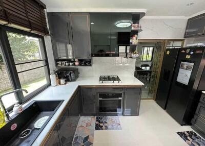 Modern kitchen with black cabinets and integrated appliances