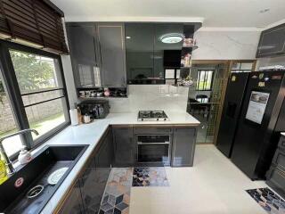 Modern kitchen with black cabinets and integrated appliances