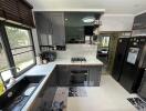 Modern kitchen with black cabinets and integrated appliances