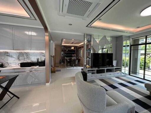 Modern living room with open kitchen and large windows