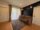 Cozy living room with a large window, sofa, and a rug