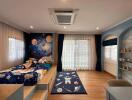 Spacious and playful children's bedroom with space-themed decor, large windows, and wooden flooring