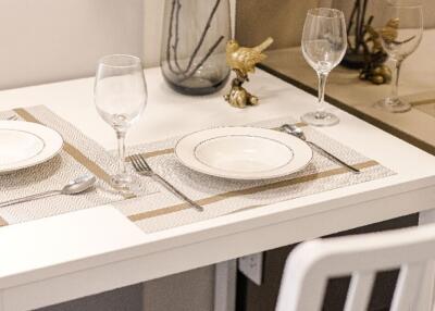 Table set for two in a dining area with elegant tableware