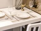 Table set for two in a dining area with elegant tableware