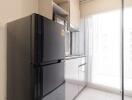 Modern kitchen with black refrigerator