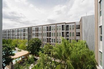 Exterior view of residential building with surrounding greenery