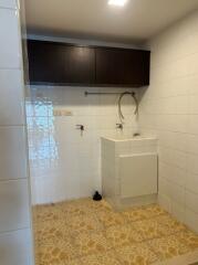 Laundry room with sink and storage cabinet