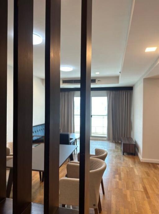 Modern living room with wooden flooring and large windows