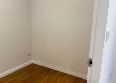 Small empty room with wooden flooring