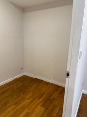 Small empty room with wooden flooring