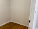 Small empty room with wooden flooring