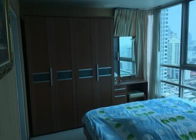 Bedroom with wardrobe and large windows