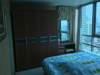 Bedroom with wardrobe and large windows