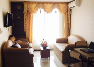 Cozy living room with leather furniture and large window