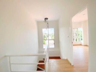 Bright and airy staircase leading to an upper floor