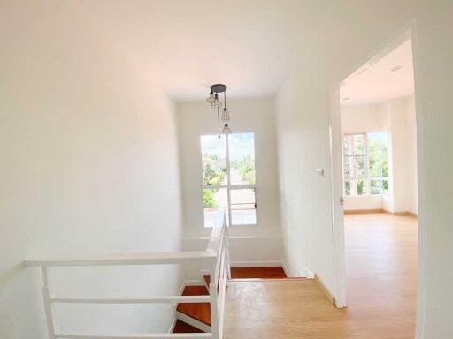 Bright and airy staircase leading to an upper floor