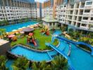 Large residential complex with outdoor pool and playground