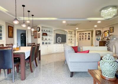 Spacious living room with dining area, modern lighting, and decorative elements