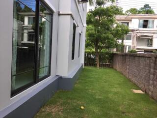 Side yard of a residential building with large windows