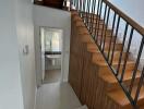 Staircase and hallway leading to a bathroom