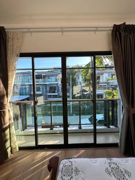 Bedroom with large sliding glass doors and balcony view