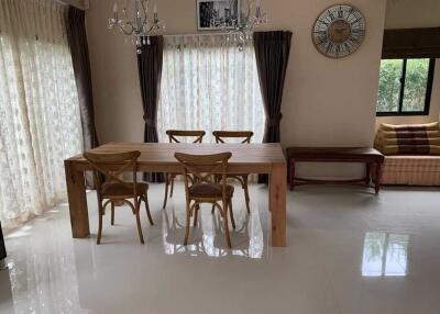 Spacious dining room with wooden table and chairs