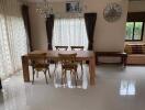 Spacious dining room with wooden table and chairs