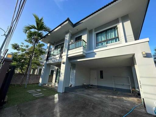 Front exterior view of a two-story modern house with a garage