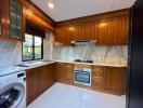 Modern kitchen with wooden cabinetry and marble countertops